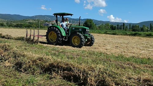 A Farmer Ploughing a Field with a Tractor