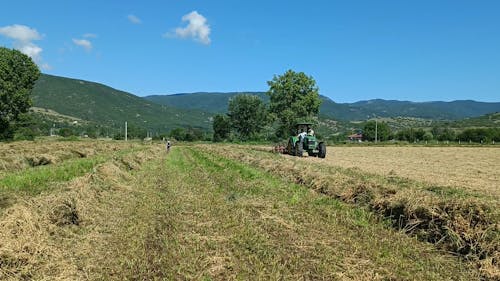 A Farmer Working on a Field with his Tractor 