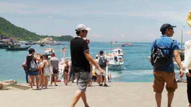 a woman is taking pictures of the ocean