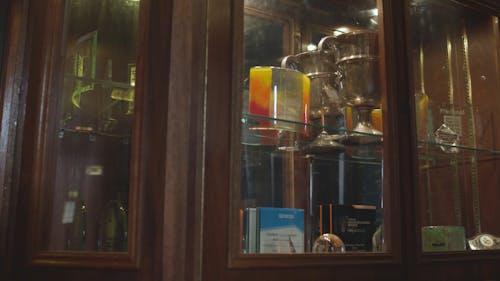 Trophies in wooden cabinet, panning shot 