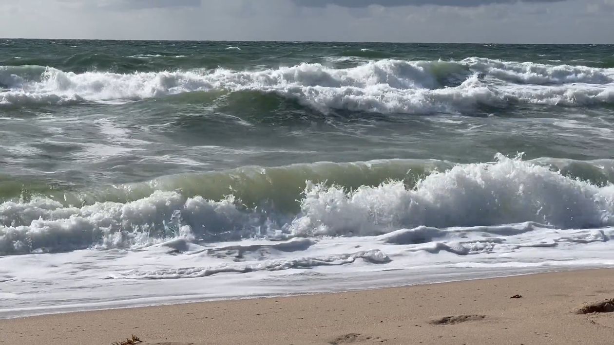 A beach with waves crashing on the shore Free Stock Video Footage ...
