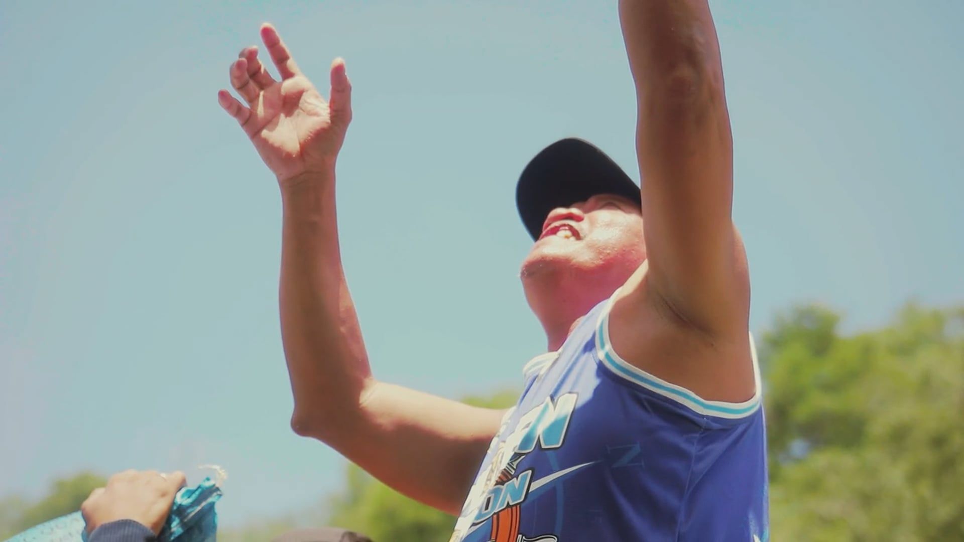 A man in a blue shirt reaching up to catch a ball Free Stock Video ...