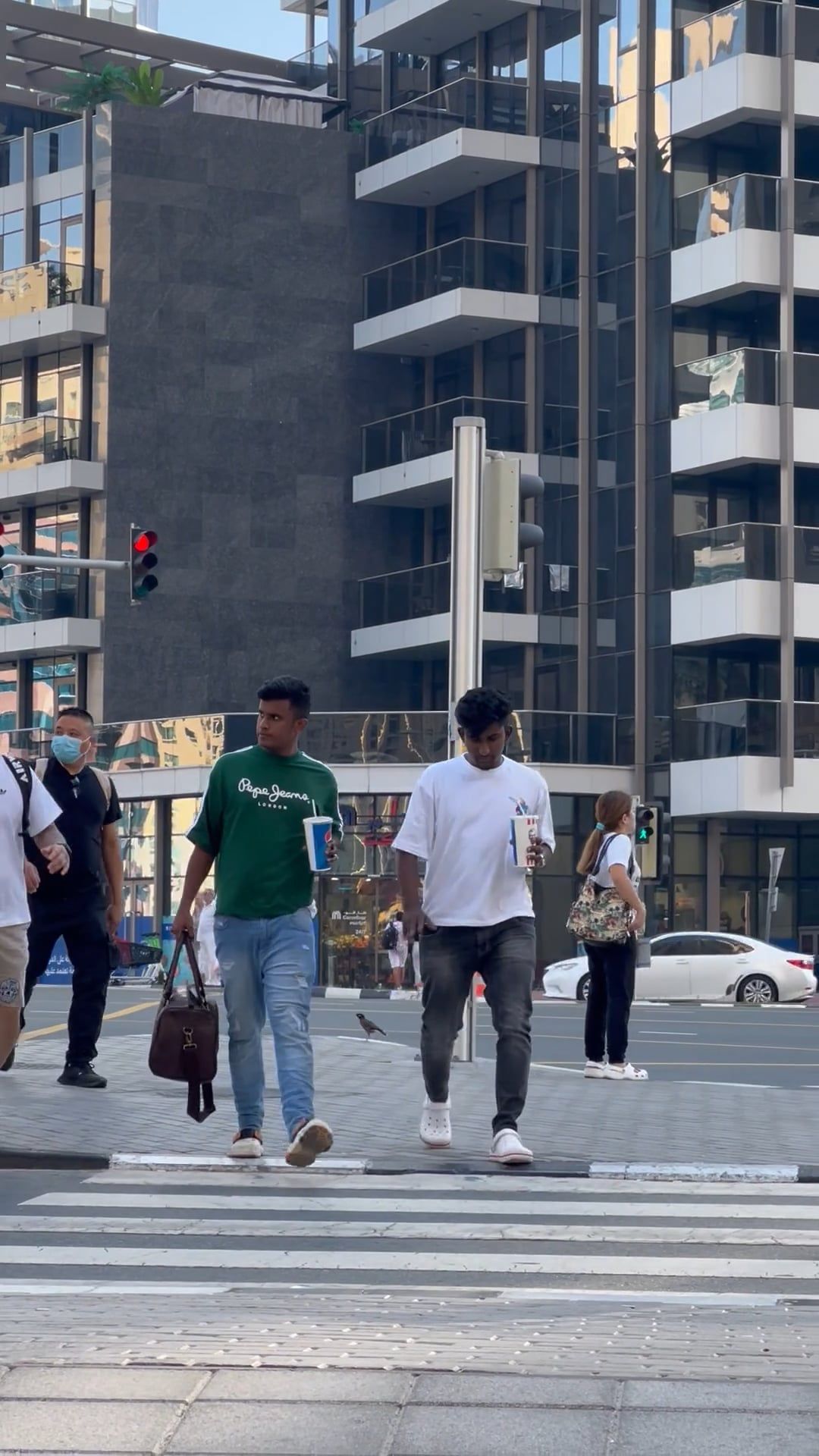 Two people walking across a crosswalk in a city Free Stock Video ...