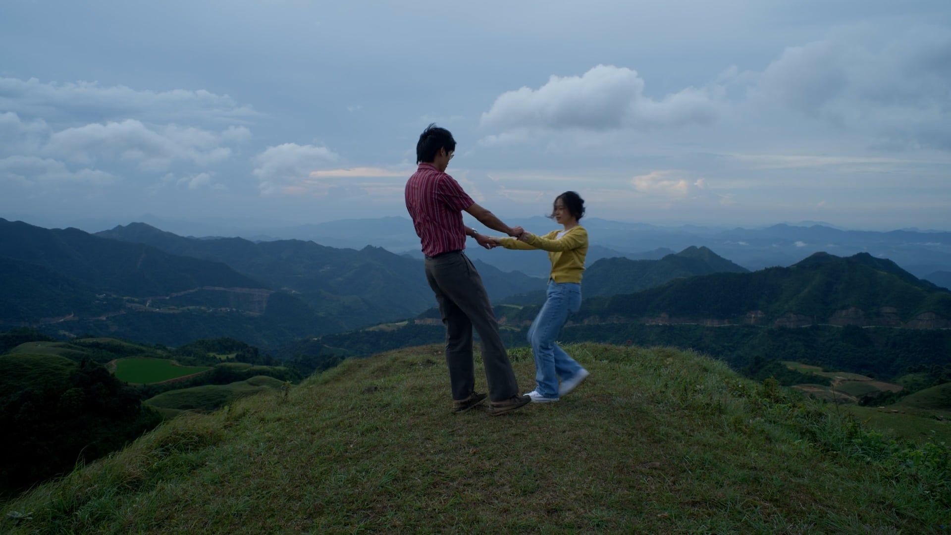 Two people are standing on top of a hill holding hands Free Stock Video ...