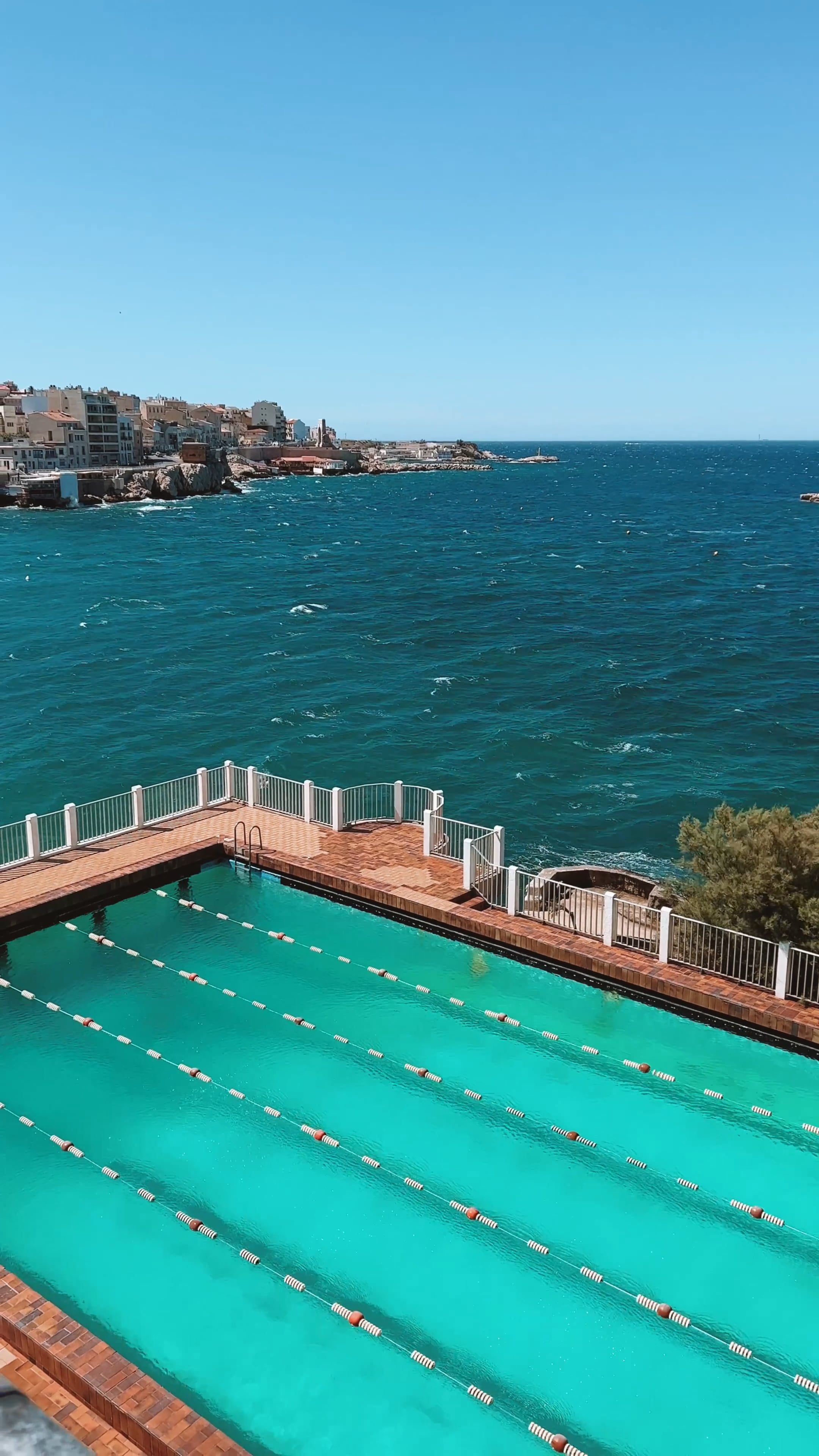 A swimming pool overlooking the ocean and a city Free Stock Video ...
