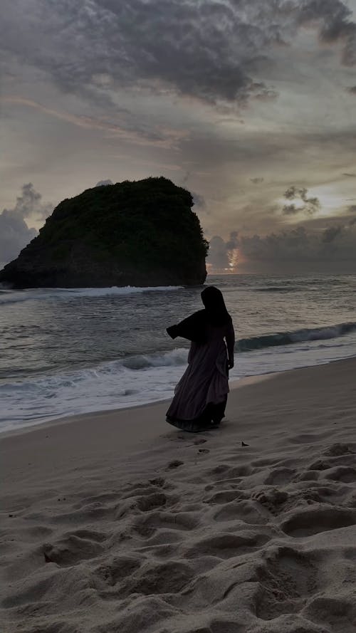 Woman walking on the sand beach