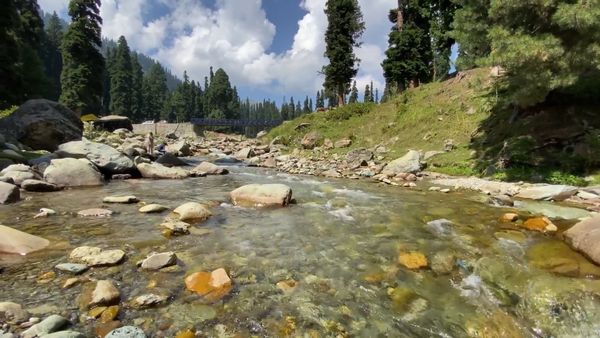 Aerial View of River Flowing Beside Road & Mountain Free Stock Video ...