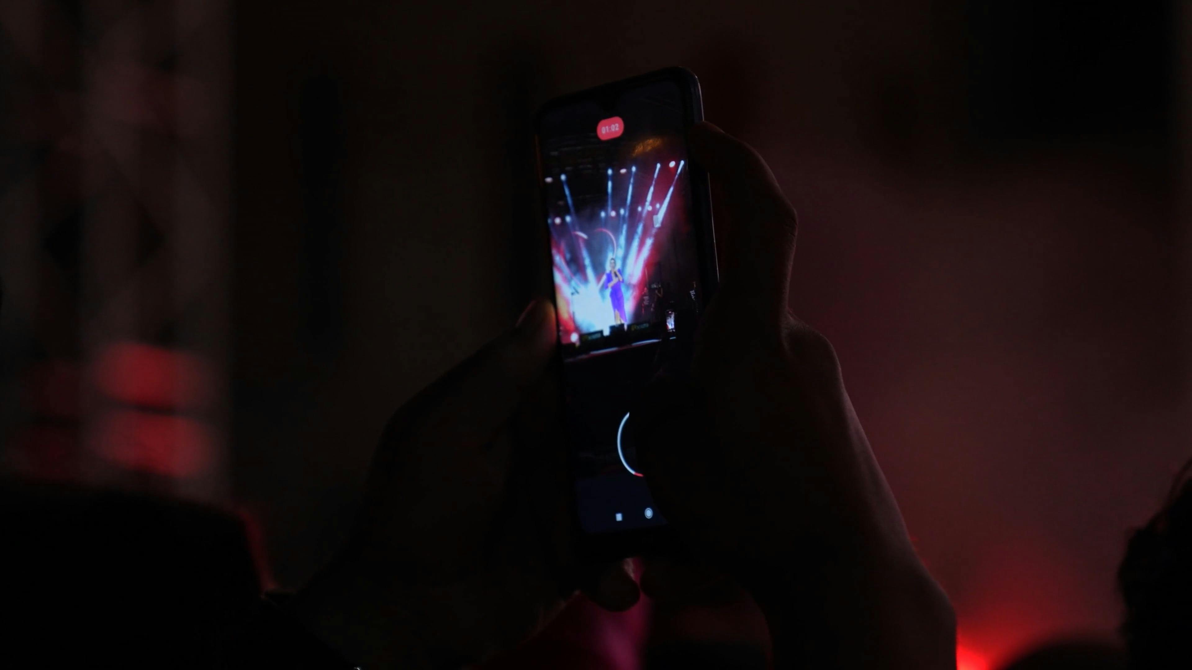 Crowd at a concert with colorful lights, representing energetic event coverage.