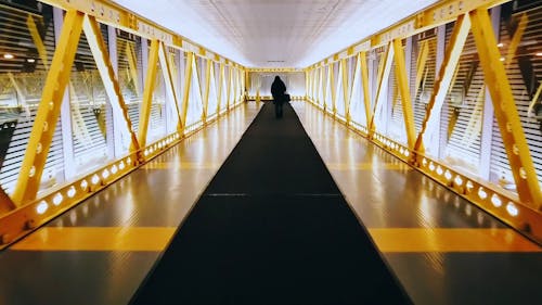 Person Walking On Footbridge