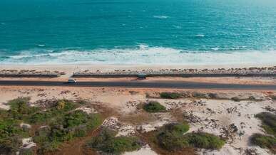 coast with waves as a background from top view blue water background from drone