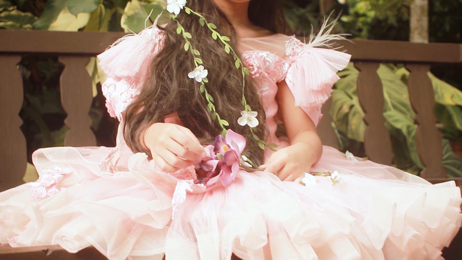 A little girl in a pink dress sitting on a bench Free Stock Video ...