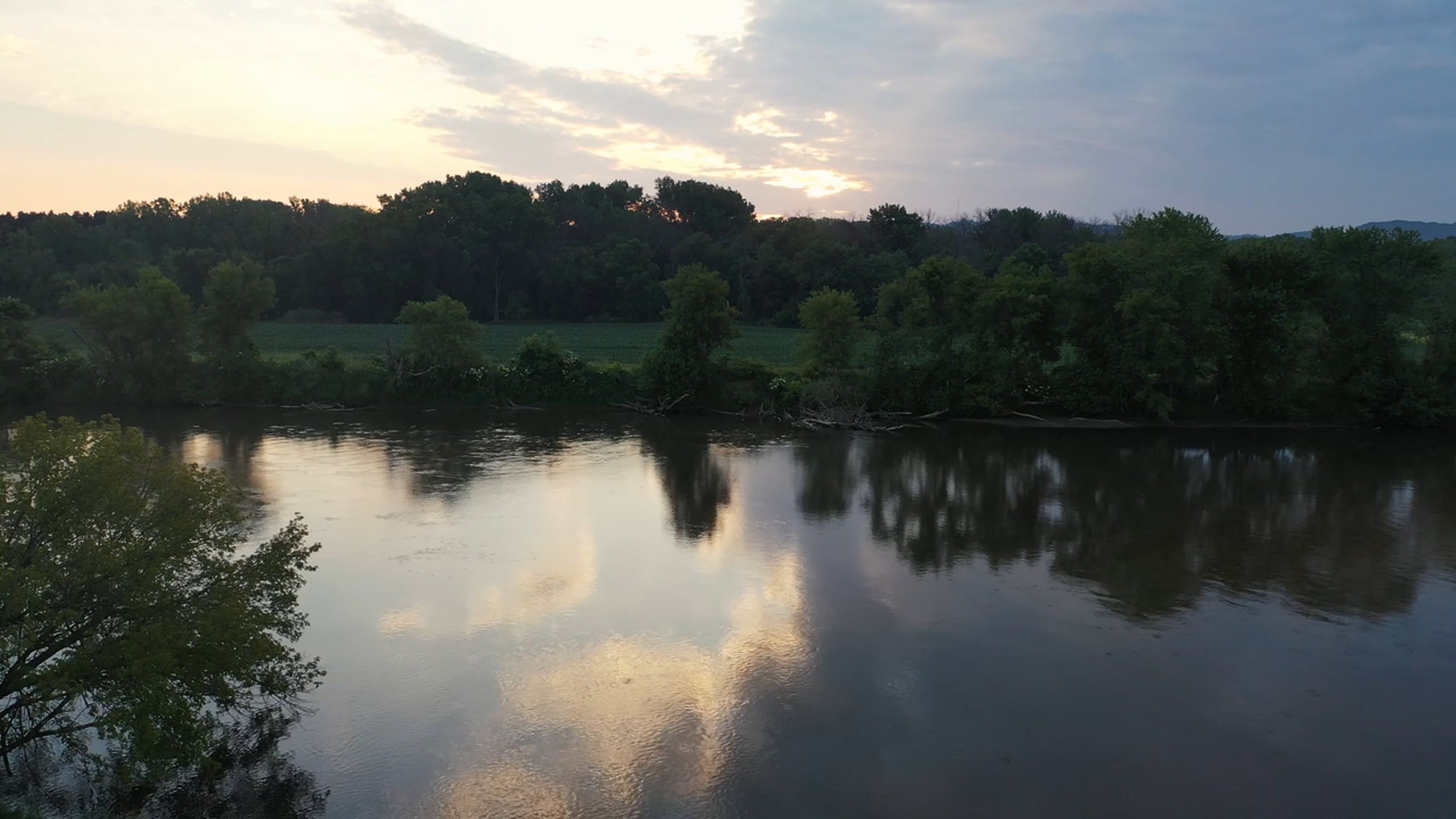 A river is seen at sunset with trees in the background Free Stock Video ...