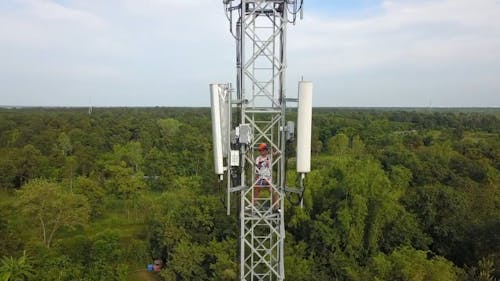 Man On A Tower Working On Power Lines