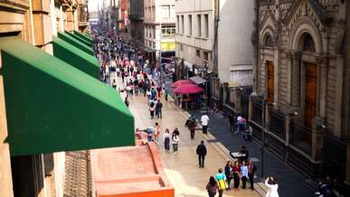 a city street with people walking and cars driving
