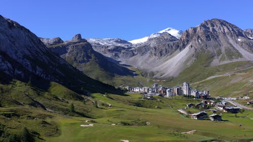 Tignes - Flying with a drone in the direction of the Val Clarey district and the Grande Motte mountain in bakcground