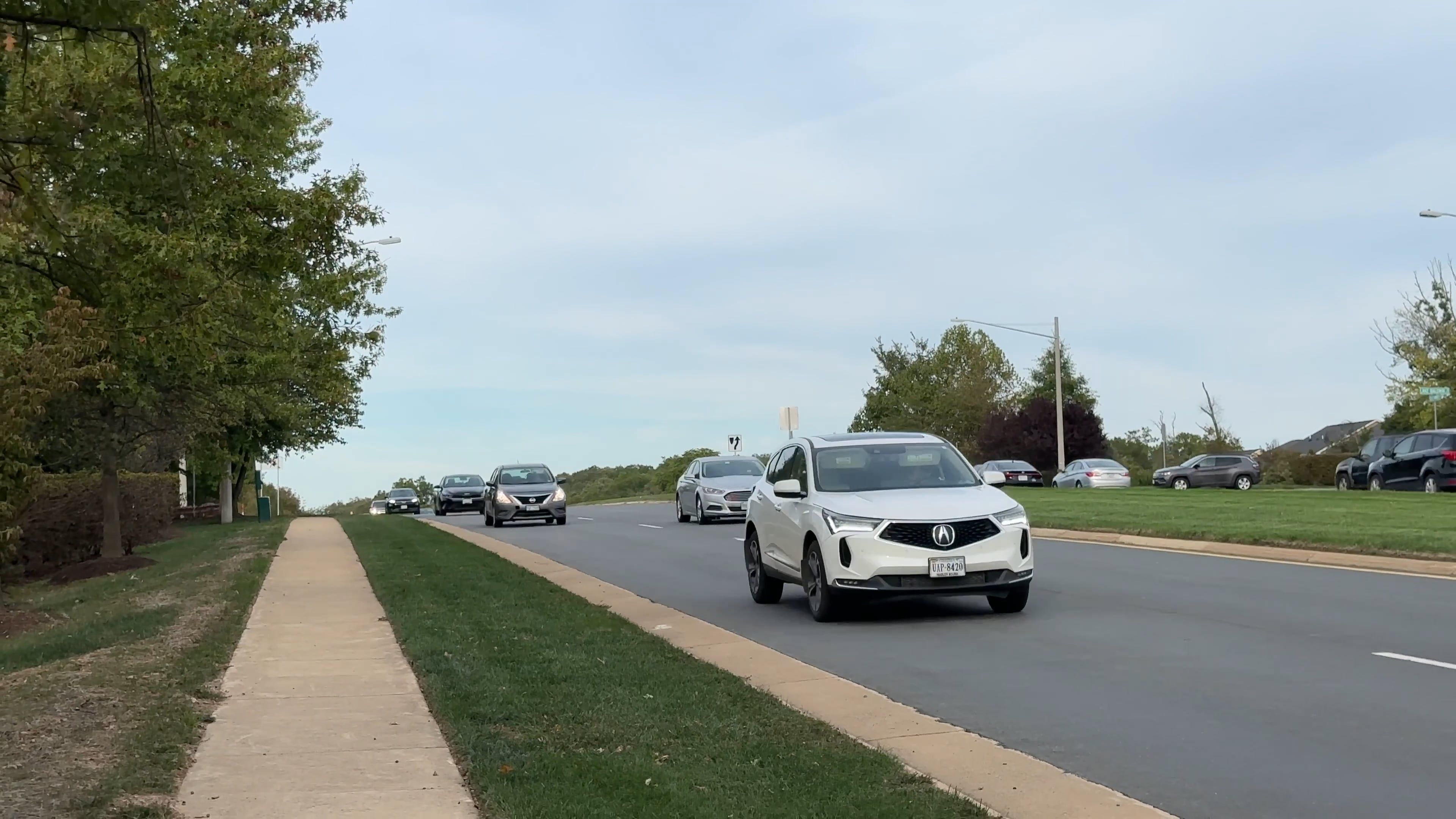 a gray nissan sentra is driving down the road 18721460