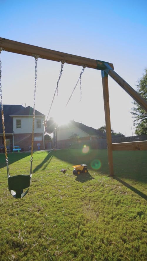 Girl swinging at sunset vertical video