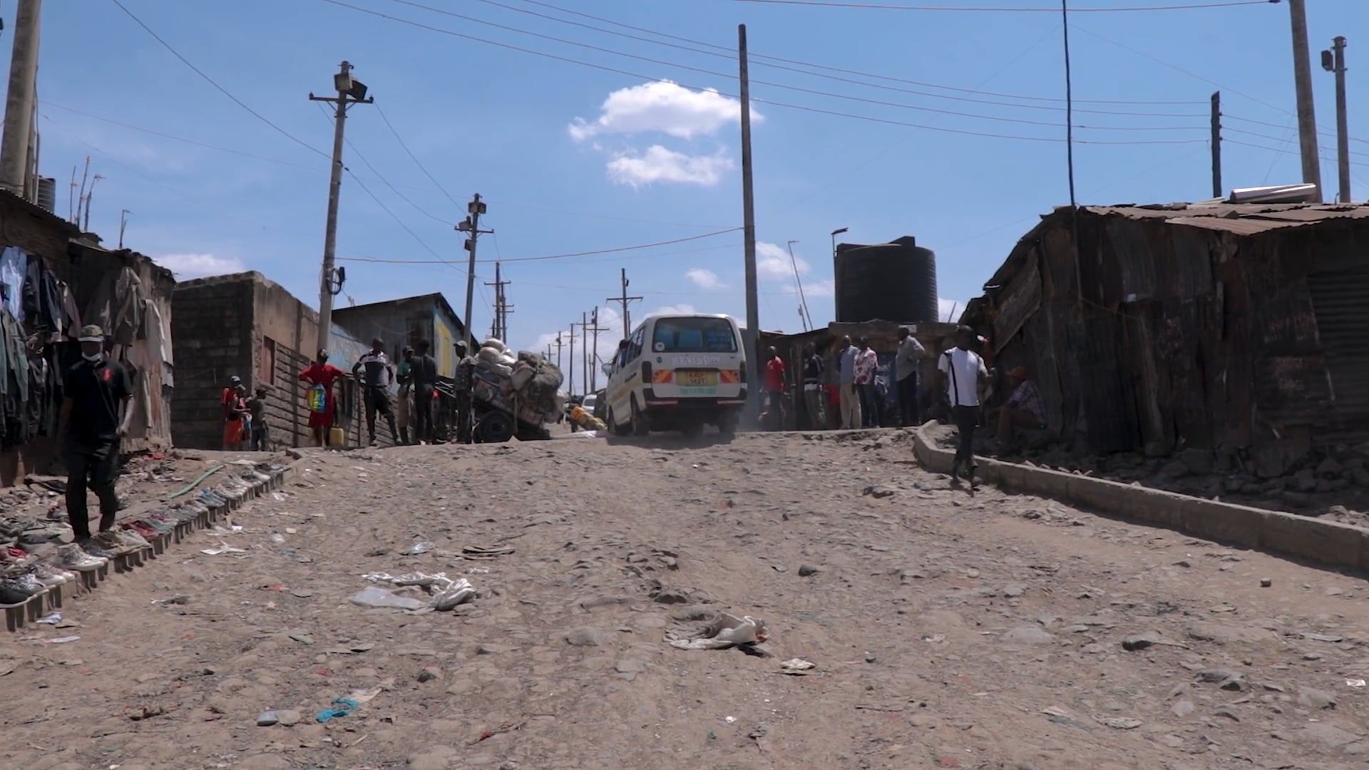 A dirt road with trash and buildings in the background Free Stock Video ...