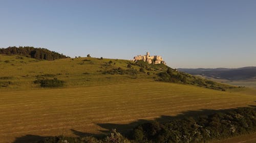 Prelet dronom popred Spišský hrad (Slovensko) pri východe slnka za slnečného počasia