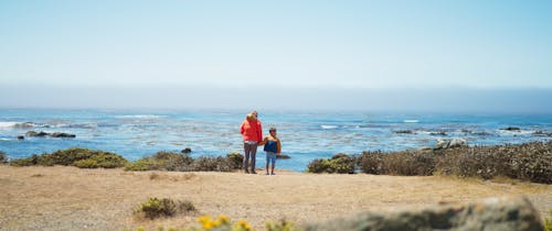 Mother and child enjoying the ocean coast line in summer 