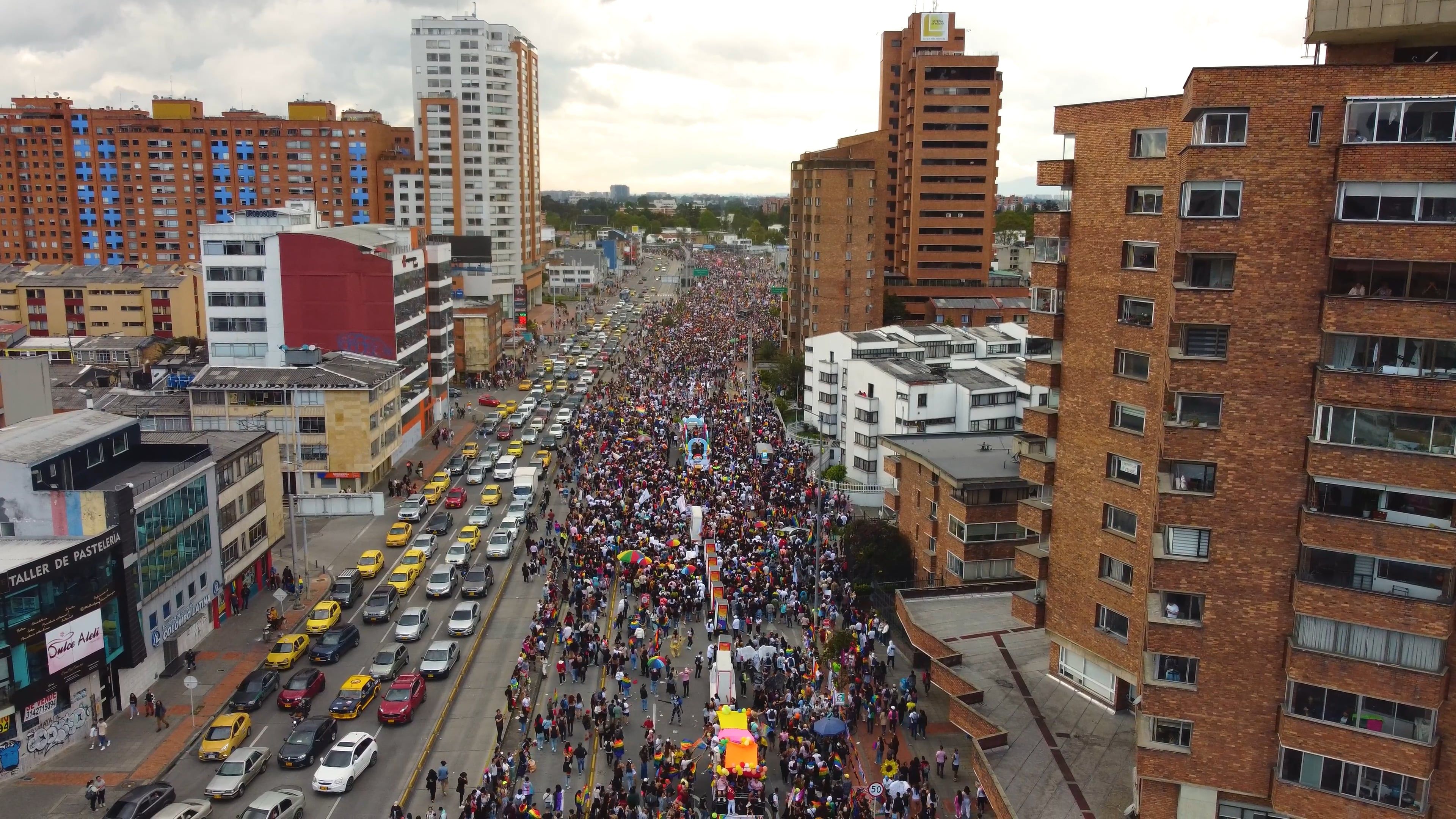A large crowd of people are marching down a street Free Stock Video ...