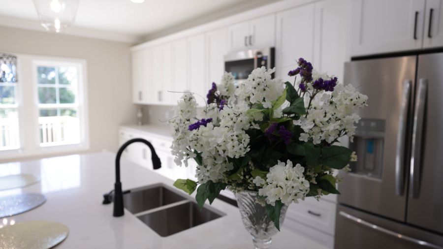Clean kitchen sink with flowers