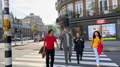 a group of people walking across a street
