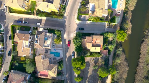 Red car driving from above