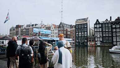 a group of people standing near a body of water