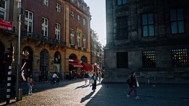 people walking on a street in a city