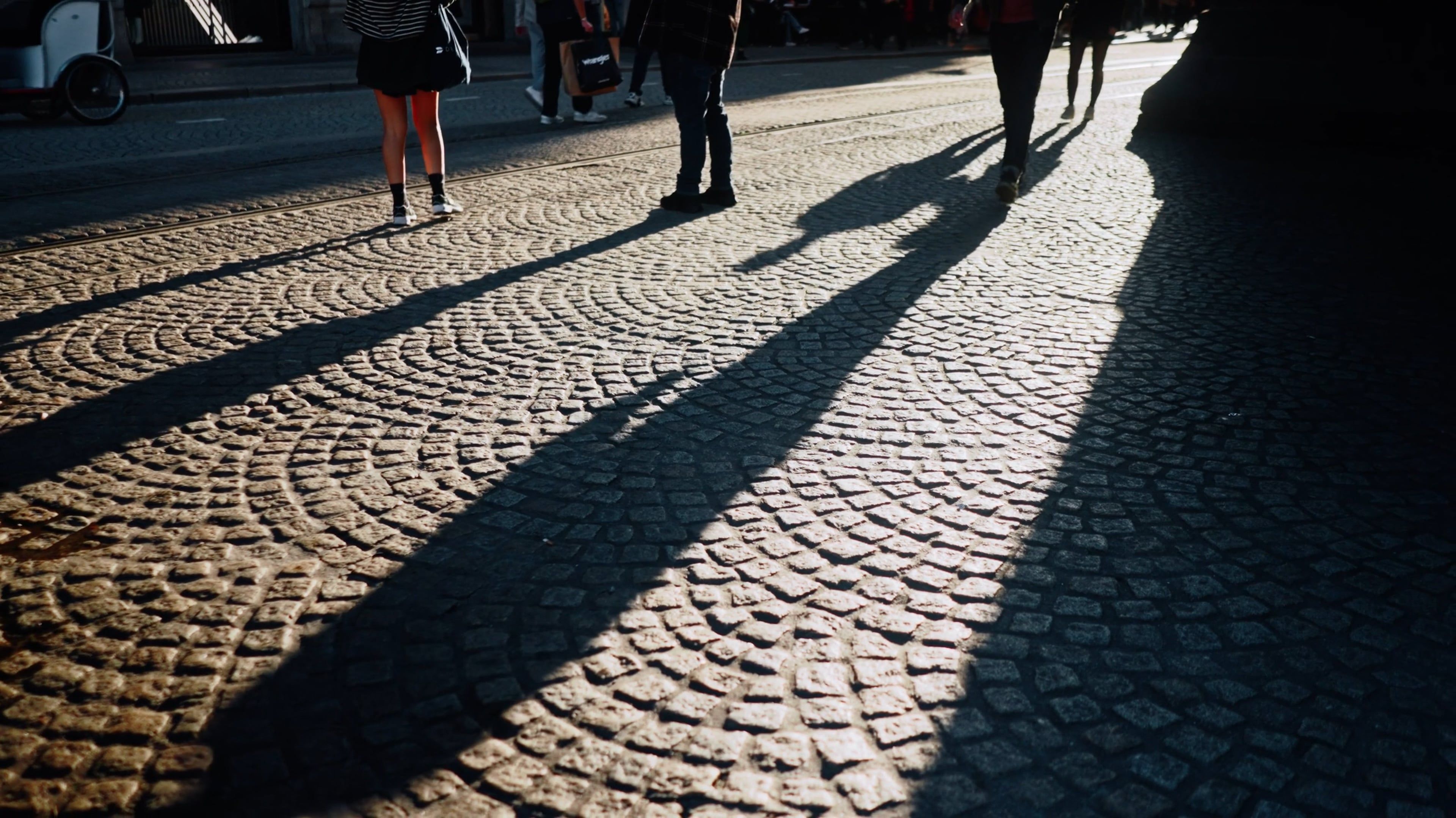 people walking on a cobblestone street in the shadow of a building 19329334 — free pexels stock footage