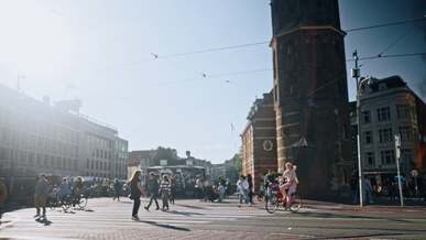 a person riding a bike in the middle of a city