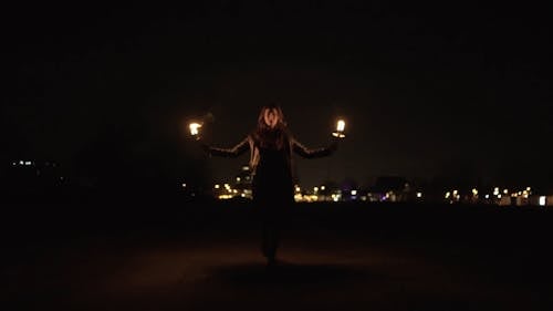 Woman Holding Torches 
