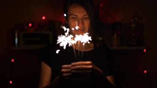Woman Holding A Bunch Of Sparklers