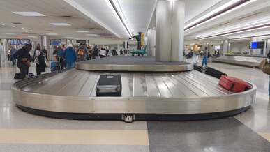 a person walking through an airport with luggage