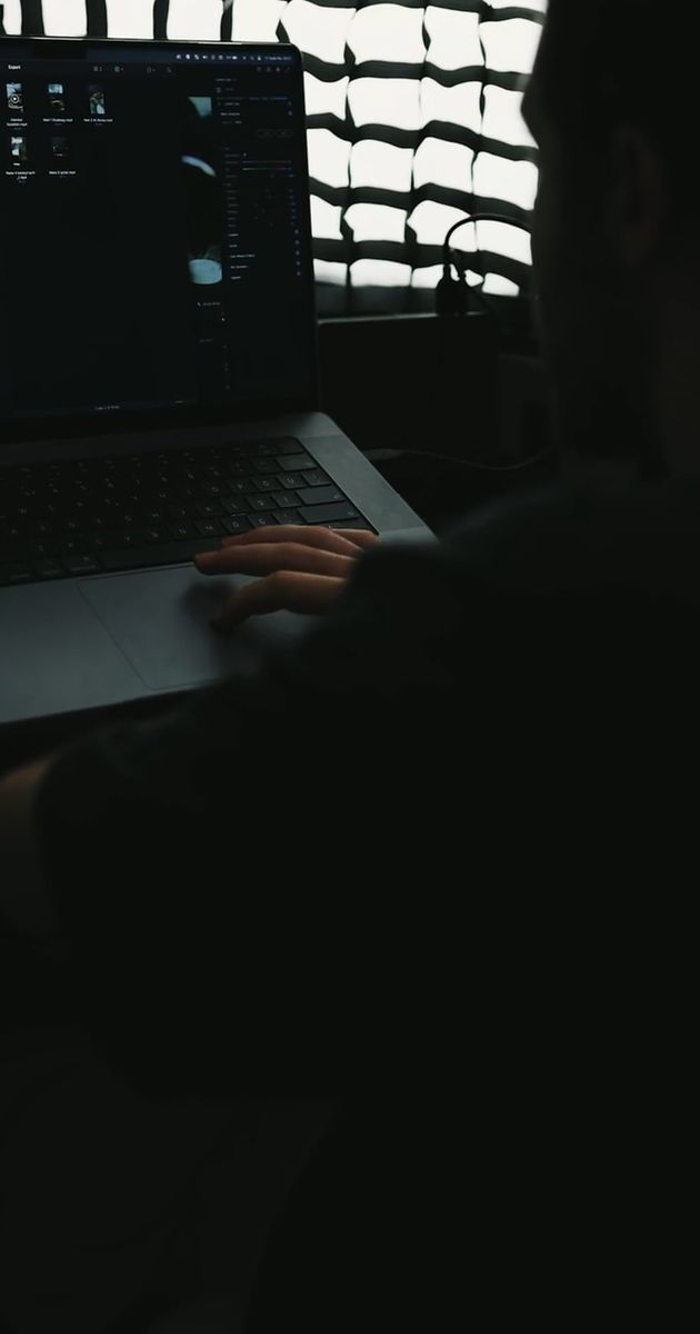 a man sitting in front of a computer screen 19532053
