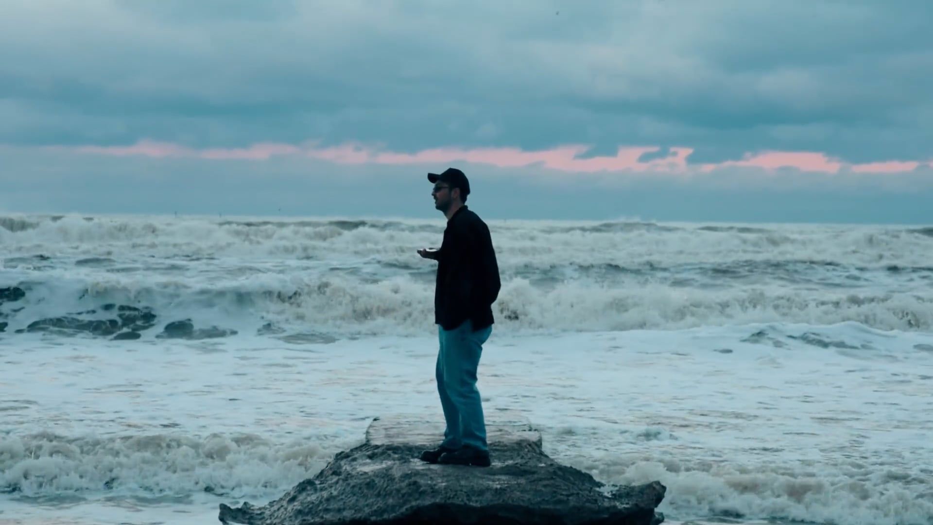 A man standing on a rock in the ocean Free Stock Video Footage, Royalty ...