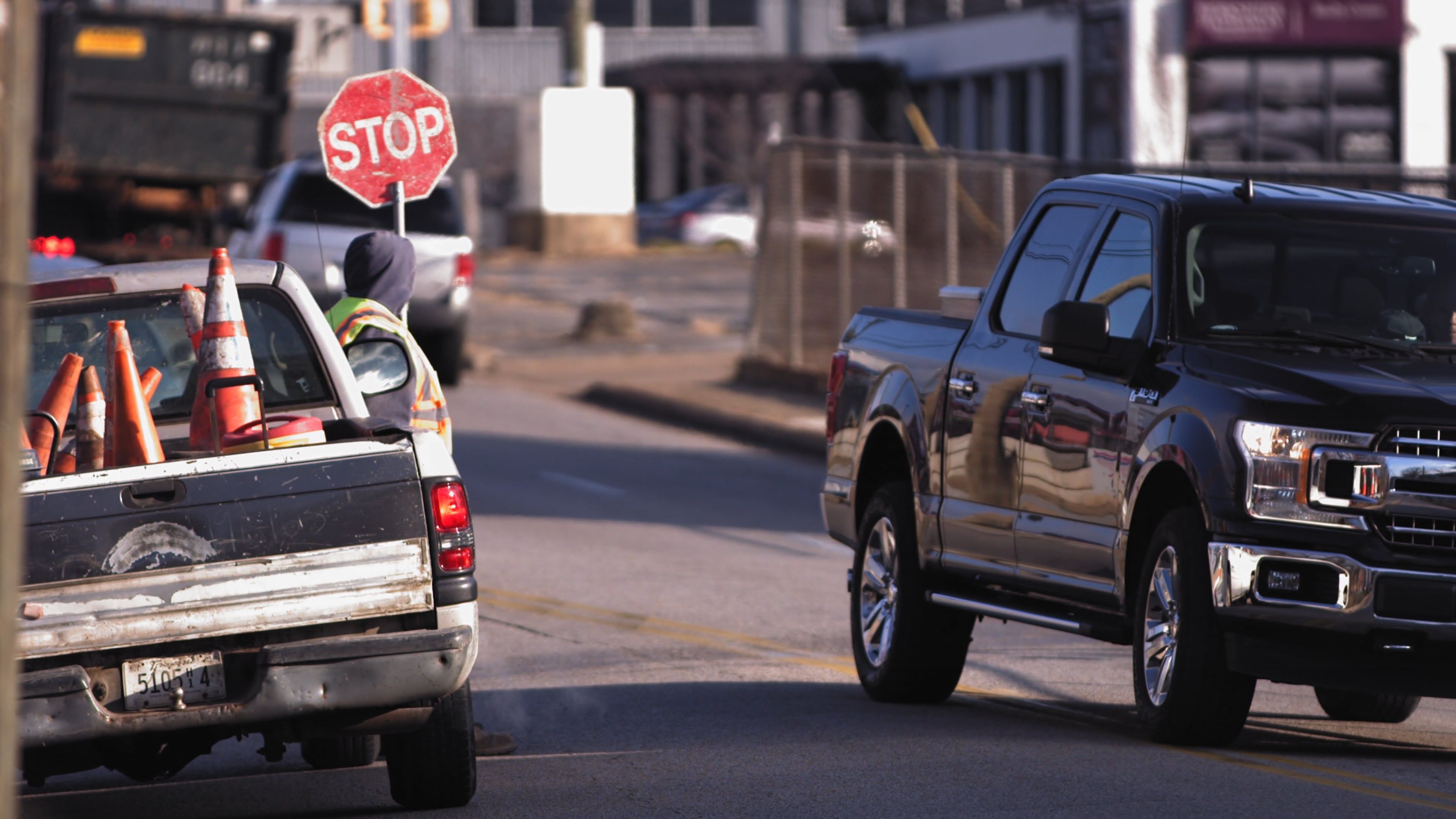 A truck is stopped at a stop sign on the side of the road Free Stock ...