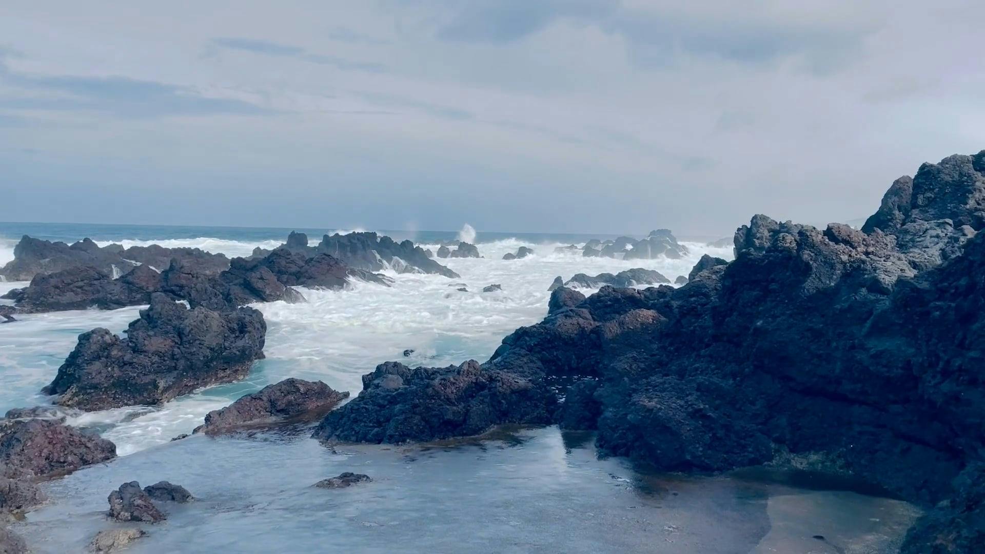 A rocky shoreline with waves crashing into the rocks Free Stock Video ...