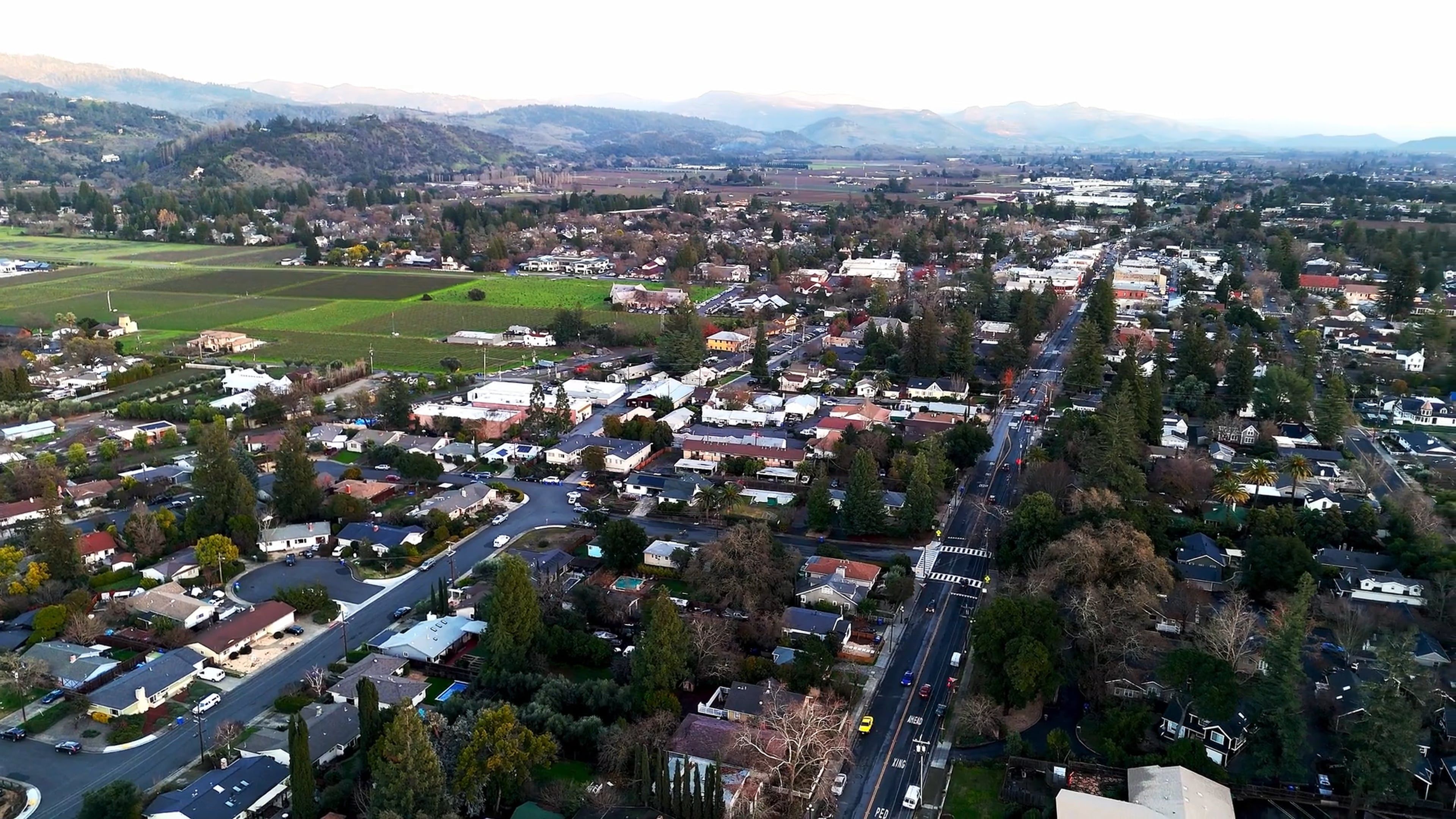 An aerial view of a city with mountains in the background Free Stock ...
