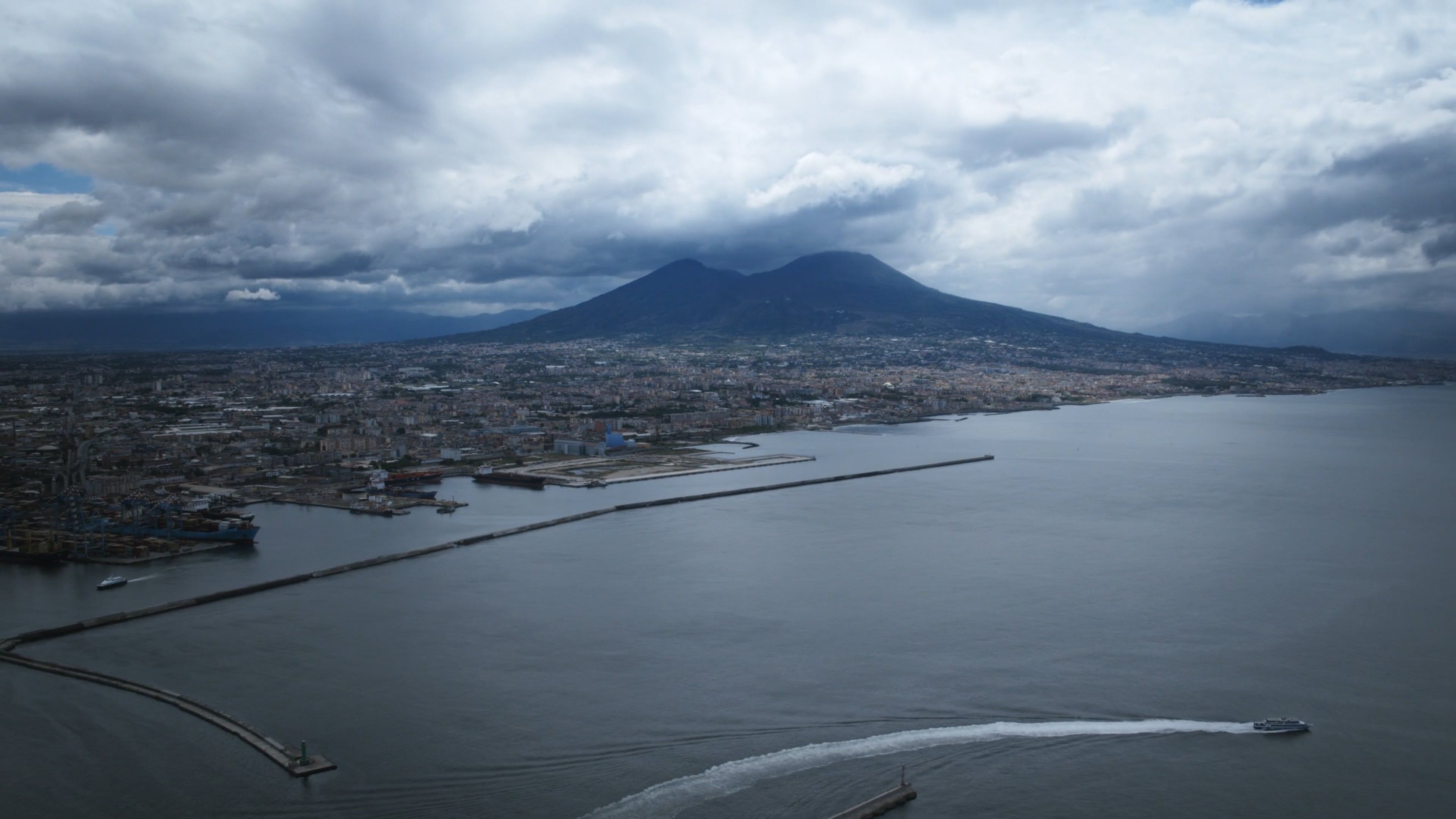 A boat is seen in the water near a volcano Free Stock Video Footage ...