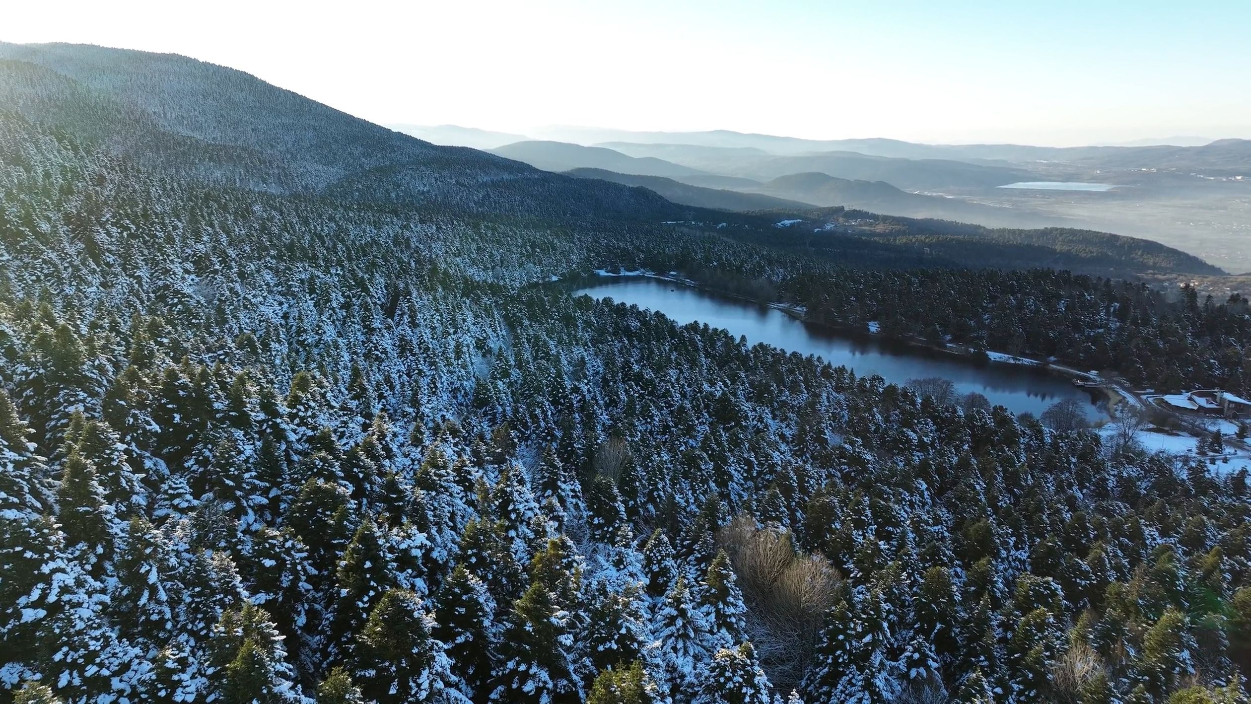 Aerial view of a lake and mountains covered in snow Free Stock Video ...