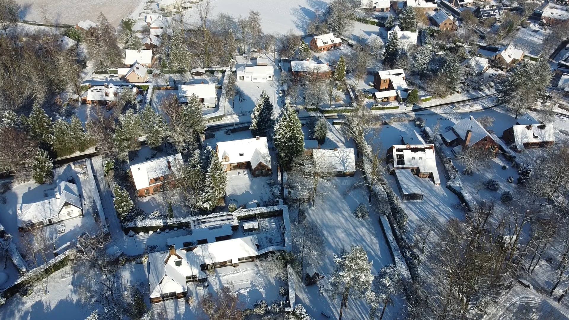 An aerial view of a snowy field with houses Free Stock Video Footage ...