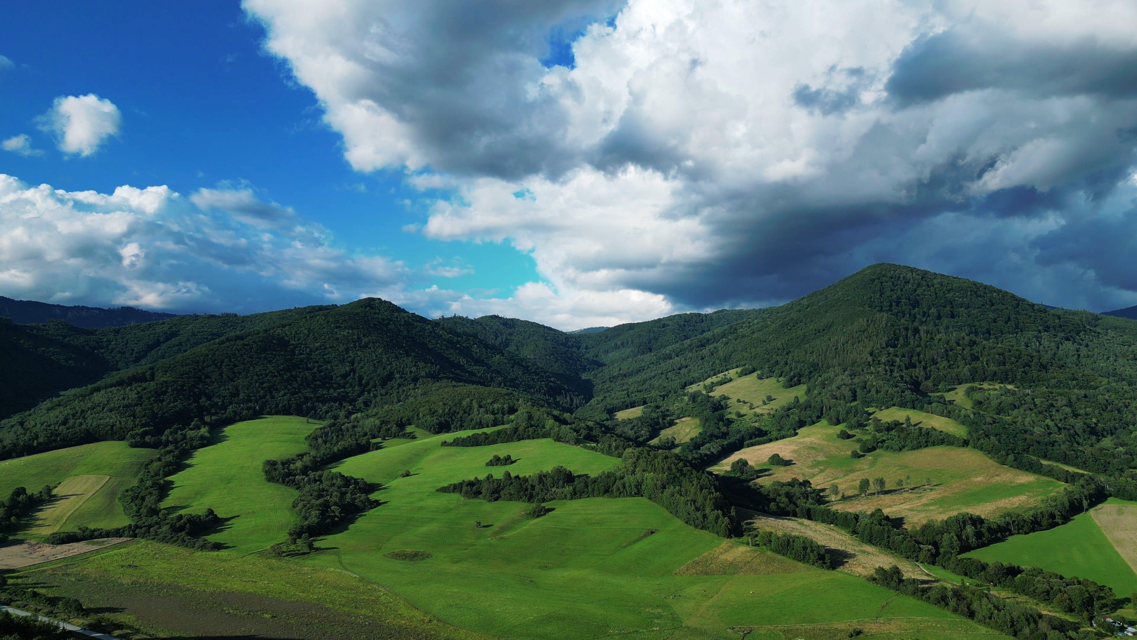 A beautiful green valley with rolling hills and clouds Free Stock Video ...