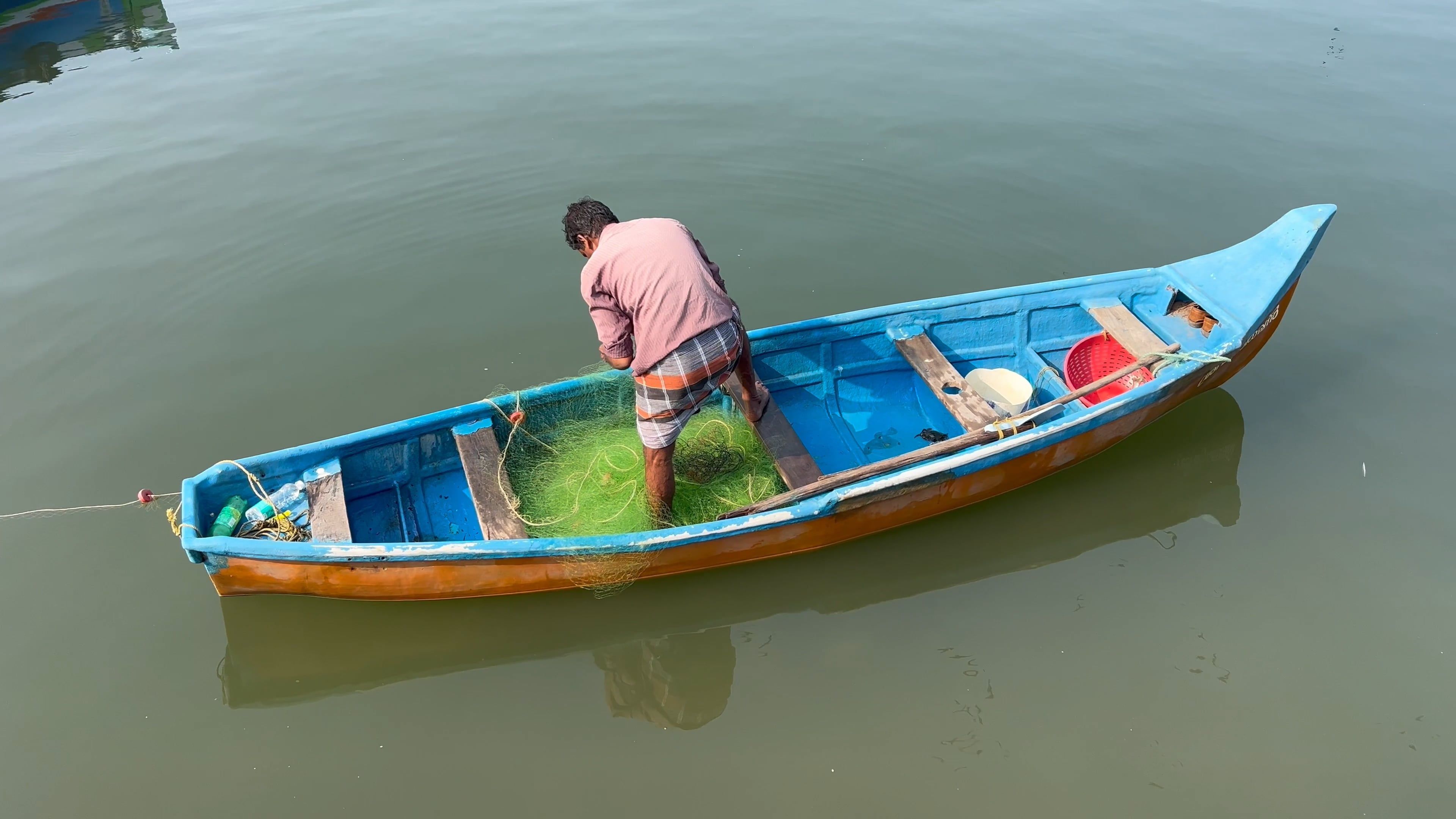 A man is standing in a small boat on the water Free Stock Video Footage ...