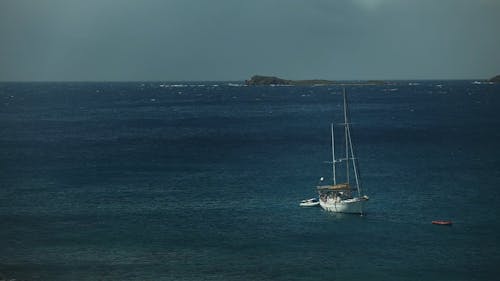 Sailboat anchored ocean breeze and rocks