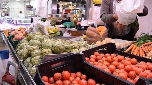 Old Woman Buying Variety Of Vegetables 