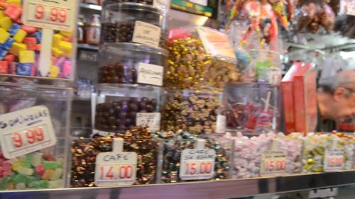 Woman Buying From A Variety Of Candies