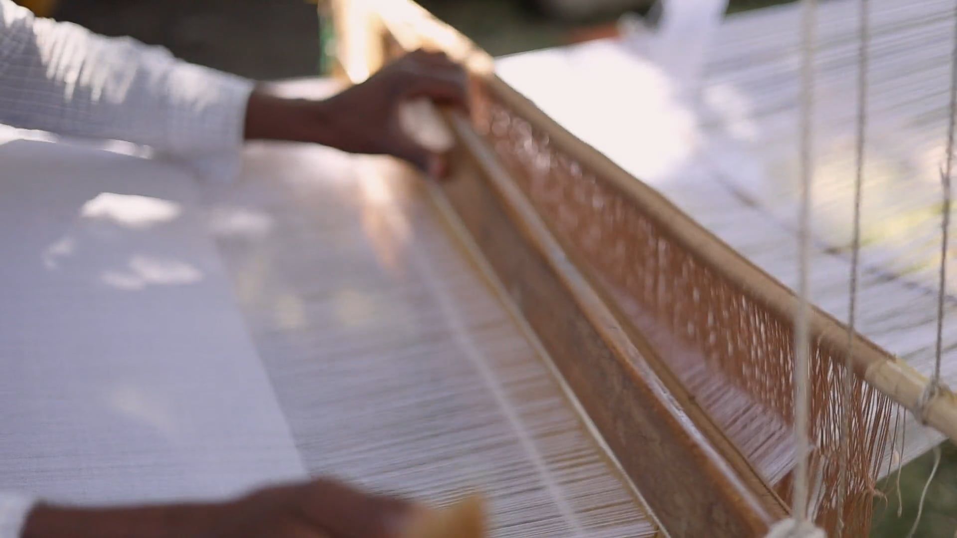 A man is weaving a piece of cloth on a loom Free Stock Video Footage ...