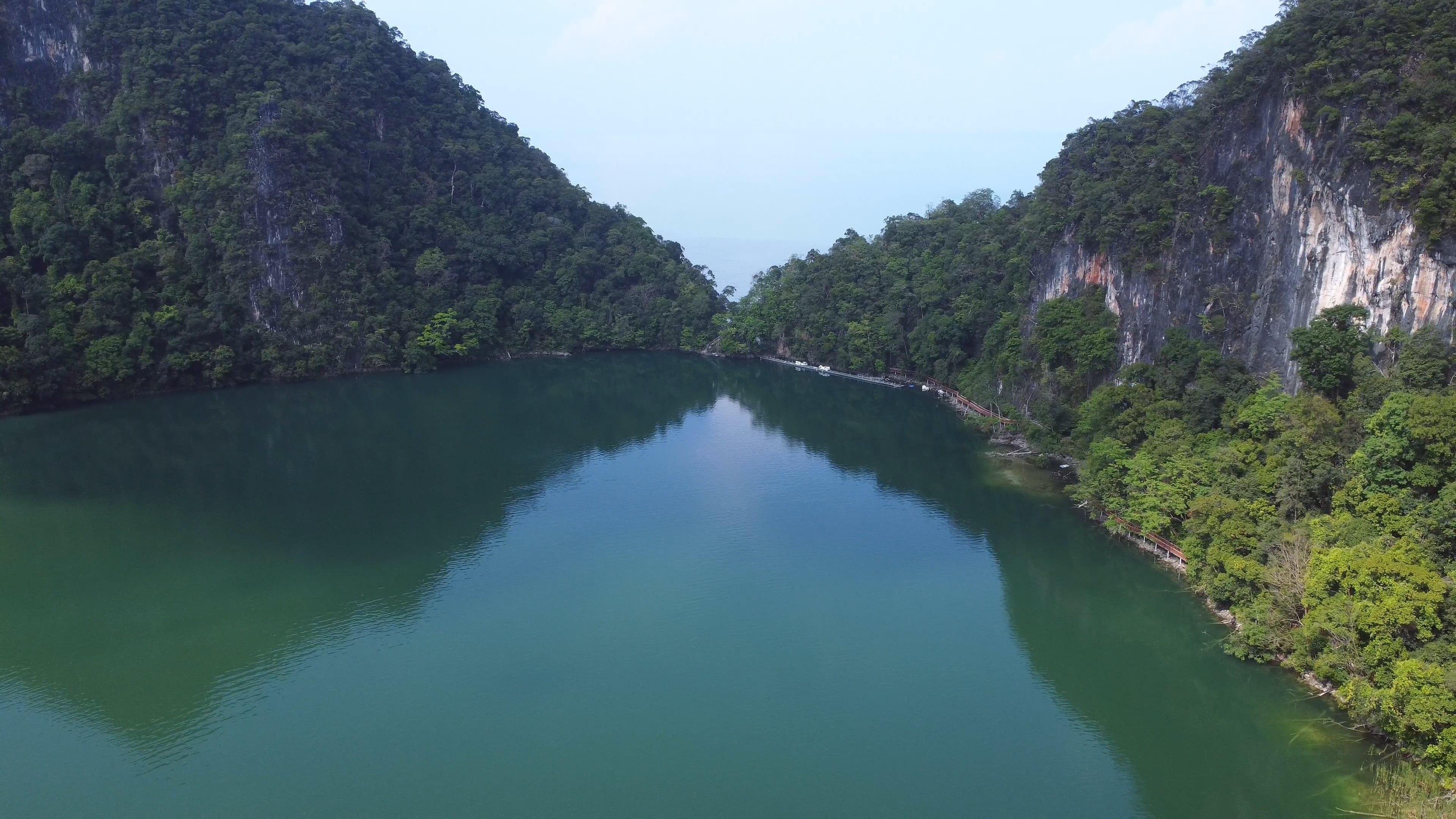 Aerial view of a lake surrounded by green mountains Free Stock Video ...